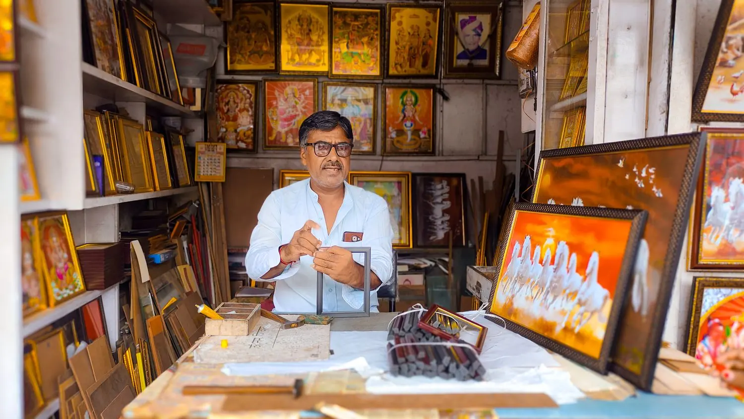 A shop owner at work in a picture-framing workshop in Jodhpur